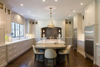 Enclosed kitchen - large transitional u-shaped dark wood floor and brown floor enclosed kitchen idea in Atlanta with an undermount sink, recessed-panel cabinets, white cabinets, marble countertops, brown backsplash, stainless steel appliances, an island and gray countertops
