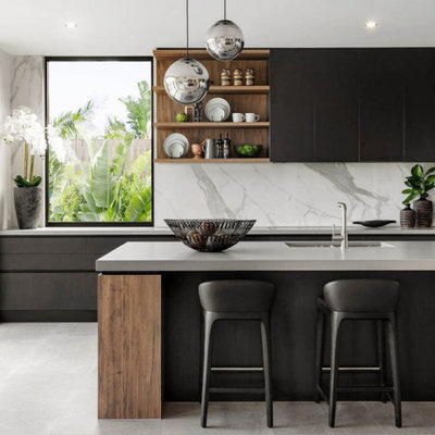 Example of a large trendy galley gray floor open concept kitchen design in Columbus with an undermount sink, flat-panel cabinets, black cabinets, quartzite countertops, white backsplash, marble backsplash, stainless steel appliances, an island and gray countertops