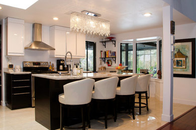 Example of a mid-sized trendy l-shaped open concept kitchen design in Orlando with flat-panel cabinets and an island