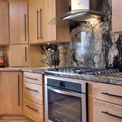 Enclosed kitchen - small contemporary u-shaped laminate floor enclosed kitchen idea in Detroit with an undermount sink, flat-panel cabinets, light wood cabinets, granite countertops, black backsplash, stone slab backsplash and stainless steel appliances