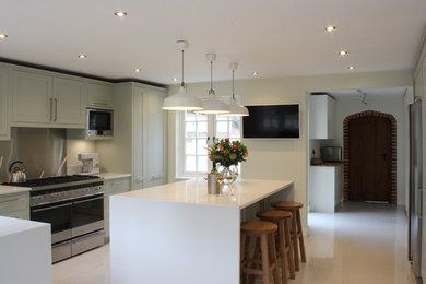 Exempel på ett modernt kök med öppen planlösning, med skåp i shakerstil, grå skåp, bänkskiva i koppar, rostfria vitvaror och en halv köksö