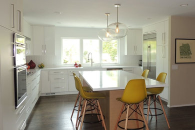 Inspiration for a large contemporary single-wall eat-in kitchen remodel in San Francisco with flat-panel cabinets, white cabinets, quartz countertops, white backsplash, porcelain backsplash, stainless steel appliances, an island and white countertops