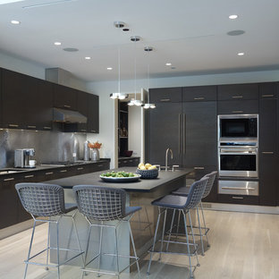Design ideas for a contemporary l-shaped kitchen in Other with panelled appliances, flat-panel cabinets, dark wood cabinets, granite benchtops, metallic splashback and metal splashback.