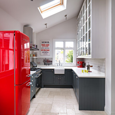 Kitchen - small transitional u-shaped kitchen idea in London with a farmhouse sink, shaker cabinets, gray cabinets, gray backsplash, subway tile backsplash and no island