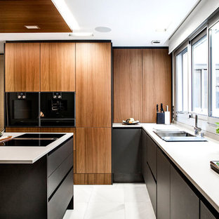 Design ideas for a small contemporary l-shaped kitchen in San Francisco with an undermount sink, flat-panel cabinets, medium wood cabinets, quartz benchtops, black appliances, marble floors, with island, white floor, white benchtop and window splashback.