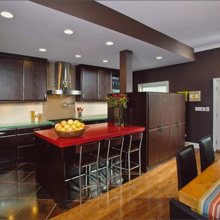 Design ideas for a large contemporary l-shaped eat-in kitchen in Chicago with stainless steel appliances, a drop-in sink, dark wood cabinets, glass benchtops, beige splashback, mosaic tile splashback, porcelain floors, with island, flat-panel cabinets and red benchtop.