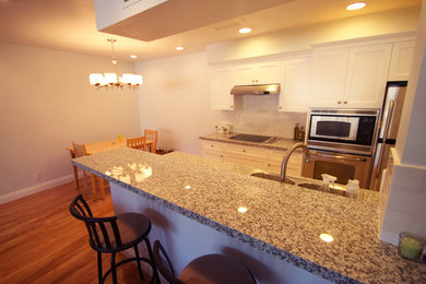 Trendy eat-in kitchen photo in Los Angeles with shaker cabinets and white cabinets