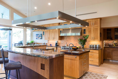 Example of a mid-sized trendy u-shaped light wood floor and beige floor open concept kitchen design in Sacramento with an undermount sink, shaker cabinets, medium tone wood cabinets, granite countertops, subway tile backsplash, stainless steel appliances, two islands and beige backsplash