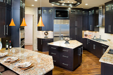 Inspiration for a large contemporary u-shaped medium tone wood floor and brown floor enclosed kitchen remodel in Other with black cabinets, granite countertops, beige backsplash, stainless steel appliances, an island, a double-bowl sink, shaker cabinets and multicolored countertops