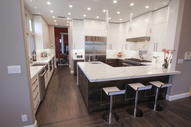 This is an example of a medium sized contemporary u-shaped kitchen/diner in San Francisco with a belfast sink, flat-panel cabinets, dark wood cabinets, engineered stone countertops, white splashback, stone slab splashback, stainless steel appliances, dark hardwood flooring, a breakfast bar, brown floors and white worktops.