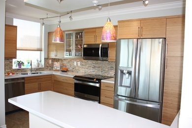 Example of a mid-sized trendy l-shaped enclosed kitchen design in Miami with an undermount sink, flat-panel cabinets, light wood cabinets, quartz countertops, multicolored backsplash, stone tile backsplash and stainless steel appliances