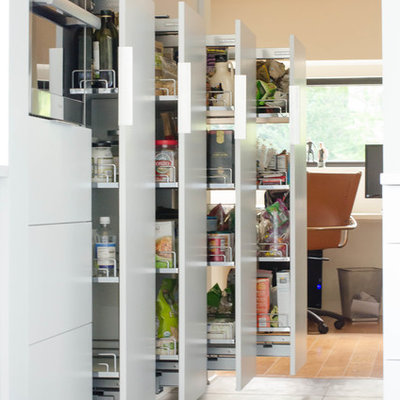 Kitchen pantry - large contemporary porcelain tile kitchen pantry idea in Kansas City with flat-panel cabinets, white cabinets and stainless steel appliances
