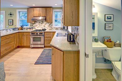 Inspiration for a mid-sized contemporary u-shaped light wood floor eat-in kitchen remodel in Other with an undermount sink, flat-panel cabinets, medium tone wood cabinets, quartz countertops, multicolored backsplash, subway tile backsplash, stainless steel appliances and an island