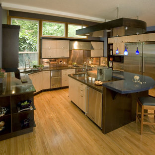 Inspiration for a contemporary kitchen in Portland with stainless steel appliances, quartz benchtops, an undermount sink, flat-panel cabinets, light wood cabinets, metallic splashback, metal splashback and blue benchtop.
