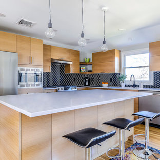 Mid-sized contemporary kitchen ideas - Kitchen - mid-sized contemporary l-shaped light wood floor and beige floor kitchen idea in New York with flat-panel cabinets, light wood cabinets, quartzite countertops, black backsplash, porcelain backsplash, stainless steel appliances, an island and white countertops