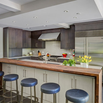 Contemporary Kitchen with Contrasting Cabinetry and Waterfall Edge Countertop