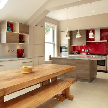 Contemporary kitchen with red splashback and vaulted ceiling