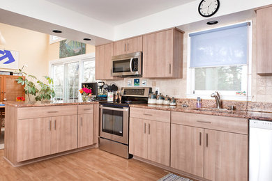 Inspiration for a mid-sized transitional u-shaped light wood floor and beige floor eat-in kitchen remodel in Baltimore with an undermount sink, flat-panel cabinets, light wood cabinets, quartz countertops, beige backsplash, ceramic backsplash, stainless steel appliances, a peninsula and multicolored countertops