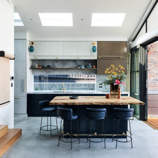 Inspiration for a contemporary galley kitchen in Sydney with marble benchtops, grey splashback, marble splashback, concrete floors, with island, grey floor, multi-coloured benchtop, an undermount sink, flat-panel cabinets and grey cabinets.
