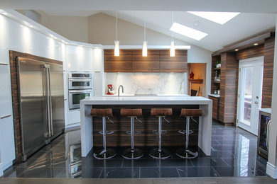 Example of a mid-sized trendy l-shaped eat-in kitchen design in Montreal with flat-panel cabinets, quartz countertops, white backsplash, stone slab backsplash, stainless steel appliances and an island
