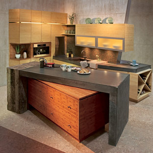Contemporary kitchen in Minneapolis with flat-panel cabinets, light wood cabinets, concrete benchtops, green splashback, glass sheet splashback and cork floors.