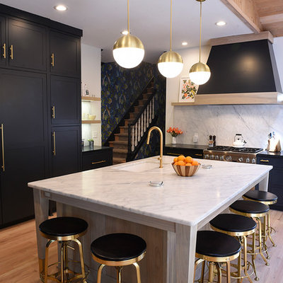 Inspiration for a large contemporary light wood floor and beige floor kitchen remodel in Cleveland with an undermount sink, shaker cabinets, black cabinets, white backsplash, an island, quartz countertops, stone slab backsplash and paneled appliances