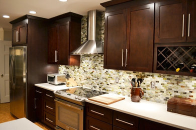 Inspiration for a modern single-wall kitchen remodel in Toronto with multicolored backsplash, mosaic tile backsplash, shaker cabinets, dark wood cabinets and stainless steel appliances