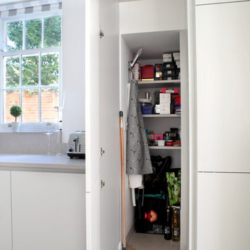 Contemporary light grey kitchen with hidden storage