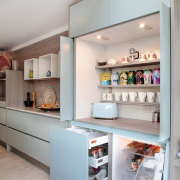 Contemporary matt grey & blue kitchen with hidden storage
