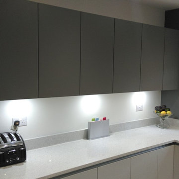 Contemporary, matt grey kitchen & contrasting dark grey wall units