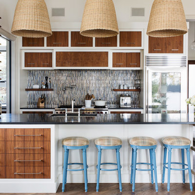 Large trendy galley medium tone wood floor and brown floor open concept kitchen photo in Toronto with an undermount sink, flat-panel cabinets, medium tone wood cabinets, granite countertops, multicolored backsplash, ceramic backsplash, stainless steel appliances and a peninsula