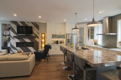 Mid-sized trendy l-shaped dark wood floor and brown floor open concept kitchen photo in Calgary with an undermount sink, shaker cabinets, white cabinets, granite countertops, green backsplash, glass tile backsplash, stainless steel appliances and an island