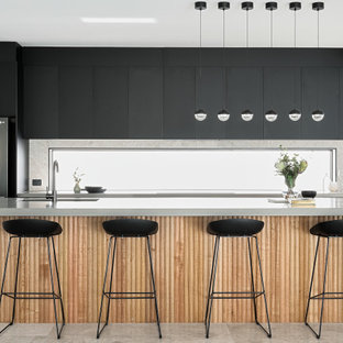 Mid-sized contemporary galley kitchen in Brisbane with an undermount sink, flat-panel cabinets, black cabinets, window splashback, stainless steel appliances, porcelain floors, with island, grey floor and grey benchtop.