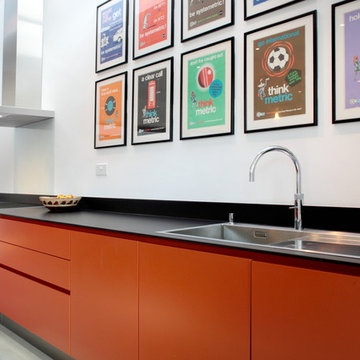 Contemporary orange kitchen with built in sink
