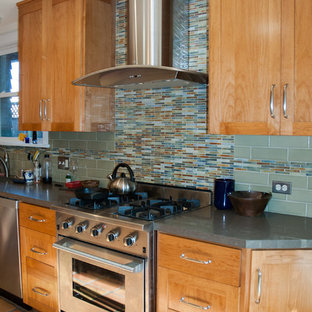 Photo of a mid-sized transitional l-shaped separate kitchen in San Francisco with shaker cabinets, light wood cabinets, green splashback, ceramic splashback, stainless steel appliances, terra-cotta floors, no island, concrete benchtops, orange floor and grey benchtop.