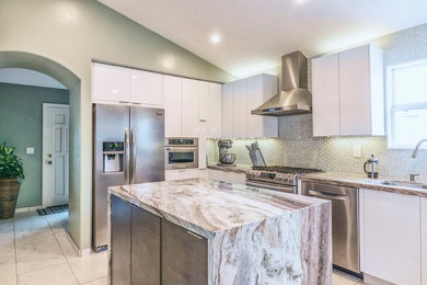 Inspiration for a contemporary l-shaped marble floor and white floor enclosed kitchen remodel in San Diego with an undermount sink, flat-panel cabinets, white cabinets, marble countertops, metallic backsplash, mosaic tile backsplash, stainless steel appliances and an island