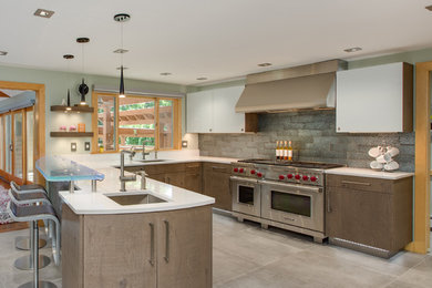 Inspiration for a large contemporary u-shaped porcelain tile and gray floor eat-in kitchen remodel in Boston with an undermount sink, flat-panel cabinets, gray cabinets, quartz countertops, metallic backsplash, glass tile backsplash, stainless steel appliances and a peninsula