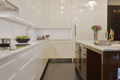 Trendy u-shaped dark wood floor and black floor eat-in kitchen photo in New York with an undermount sink, flat-panel cabinets, white cabinets, quartzite countertops, white backsplash, glass tile backsplash, white appliances, an island and multicolored countertops