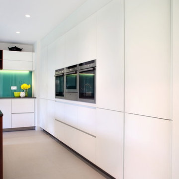 Contemporary white kitchen with built in tall units