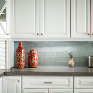 Contemporary white kitchen with silver subway tiles