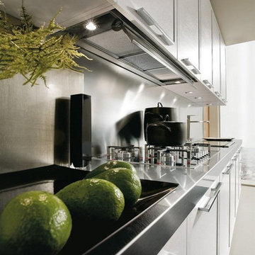 Contemporary white single wall kitchen with stainless steel backsplash