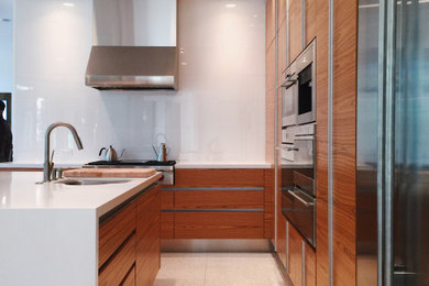Large trendy kitchen photo with light wood cabinets, stainless steel appliances and an island