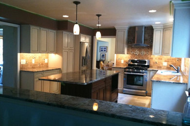 Example of a mid-sized transitional u-shaped ceramic tile and beige floor open concept kitchen design in New York with an undermount sink, recessed-panel cabinets, white cabinets, granite countertops, beige backsplash, ceramic backsplash, stainless steel appliances and an island