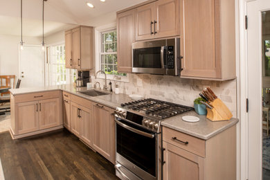 Eat-in kitchen - mid-sized modern galley dark wood floor and brown floor eat-in kitchen idea in Detroit with a single-bowl sink, shaker cabinets, light wood cabinets, quartz countertops, gray backsplash, porcelain backsplash, stainless steel appliances, a peninsula and gray countertops