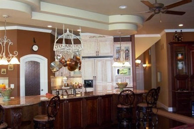 Example of a large classic single-wall dark wood floor open concept kitchen design in Chicago with a double-bowl sink, raised-panel cabinets, distressed cabinets, granite countertops, beige backsplash, ceramic backsplash, white appliances and an island