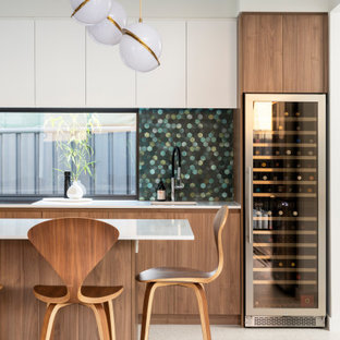 Inspiration for a midcentury galley kitchen in Perth with an undermount sink, flat-panel cabinets, medium wood cabinets, green splashback, mosaic tile splashback, with island, white floor and white benchtop.