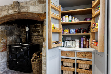 Eat-in kitchen - traditional eat-in kitchen idea in Dorset with shaker cabinets and an island