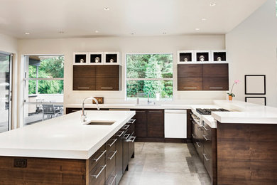 Example of an eat-in kitchen design in Wilmington with solid surface countertops