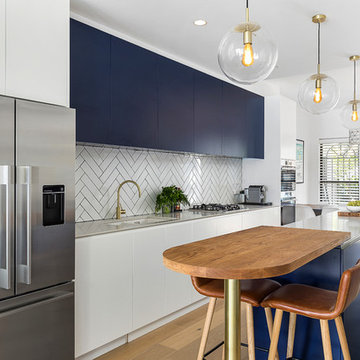 Contemporary blue kitchen with chevron tiled splashback