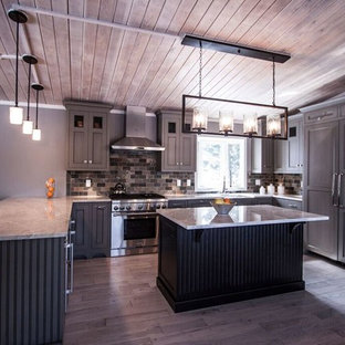 This is an example of a mid-sized transitional u-shaped eat-in kitchen in Chicago with a farmhouse sink, flat-panel cabinets, green cabinets, quartzite benchtops, multi-coloured splashback, stone tile splashback, panelled appliances, light hardwood floors and with island.